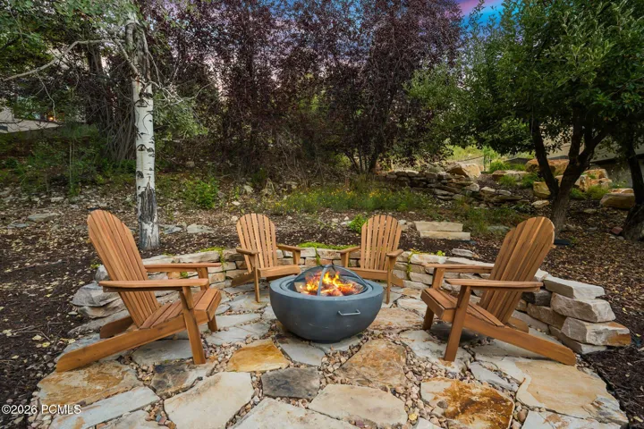Stone paver pathway leading to a stone fire pit area in the back/side yard. Imagine getting out the gravity chairs and taking in the stars or sunsets.