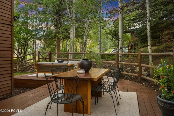 Secluded and private back deck right off the kitchen and dining room with multiple seating areas for entertaining, relaxing, working from home, and being immersed in nature. The home often sees moose, deer, rabbits, squirrels, birds and less commonly elk, bobcats, fox and raccoons
