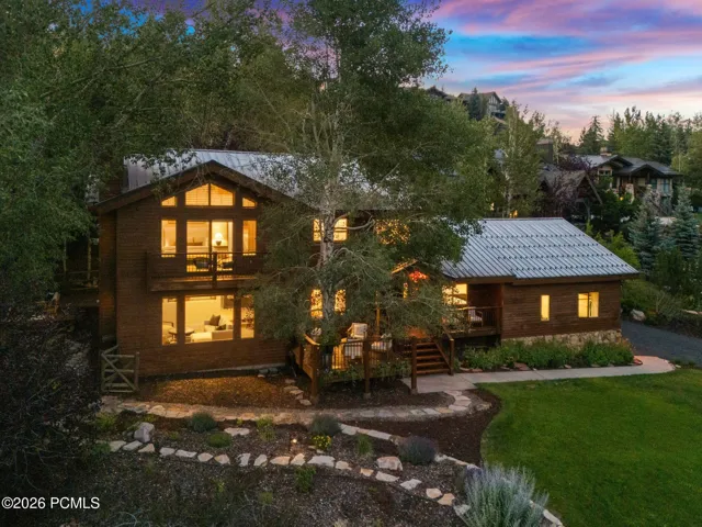 Front view of 1936 Kidd Cir. with tastefully done xeriscaping and a nice grassy area with mature trees.