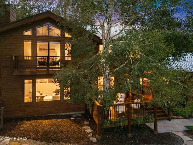 Front view of 1936 Kidd Cir. with tastefully done xeriscaping and a nice grassy area with mature trees.