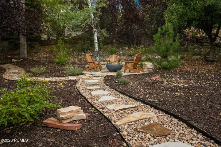 Stone paver pathway leading to a stone fire pit area in the back/side yard. Imagine getting out the gravity chairs and taking in the stars or sunsets.