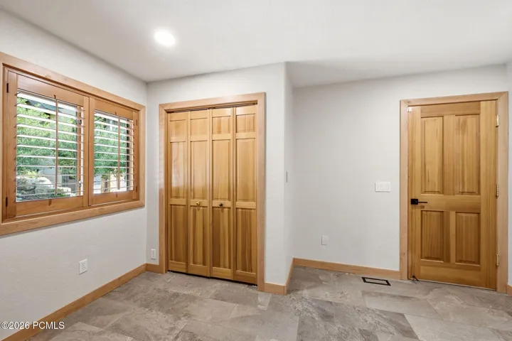 Mudroom with ample storage and heated floors right off of the garage entrance into the home.