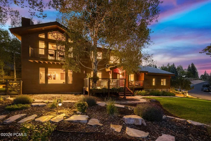 Front view of 1936 Kidd Cir. with tastefully done xeriscaping and a nice grassy area with mature trees.
