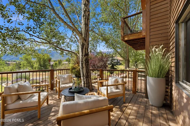 Front deck with a tree integrated into the deck and stunning views of Park City, Canyons, and Deer Valley. Imagine watching the fireworks from your front deck!