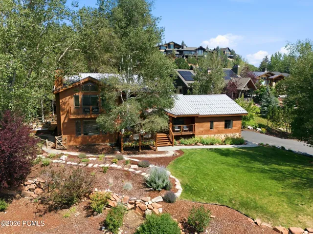 Front view of 1936 Kidd Cir. with tastefully done xeriscaping and a nice grassy area with mature trees.