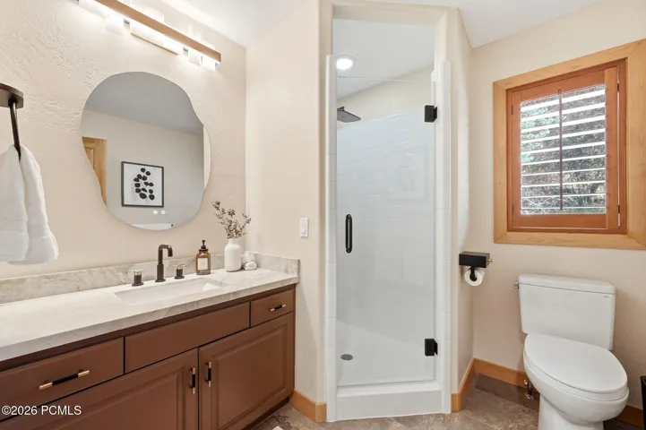 The first-level three-quarter bathroom has been fully updated and has heated floors and Taj Mahal quartzite countertops.