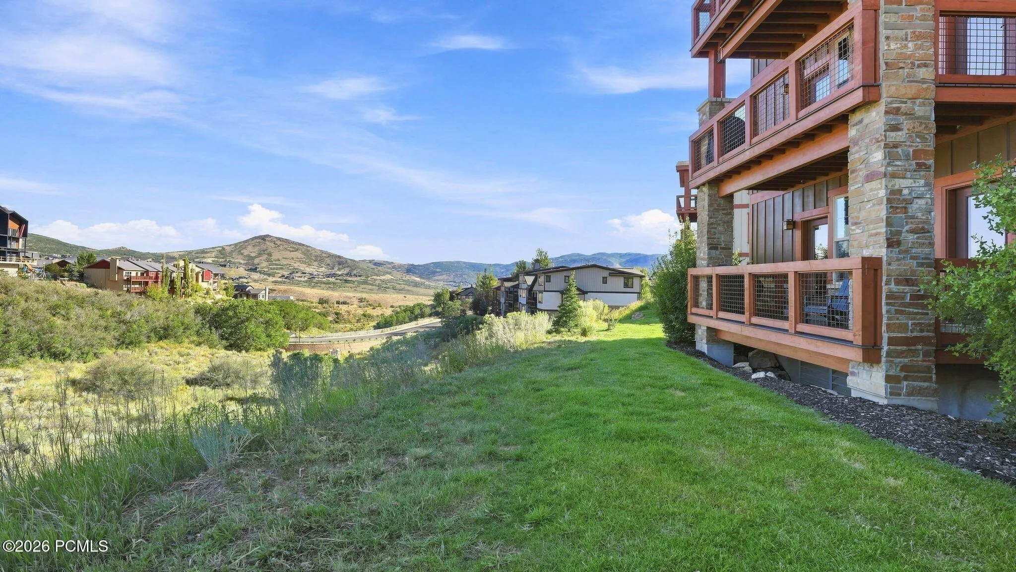 Exterior with lawn and mountain views - Deer Park 102, Jordanelle, Heber City UT