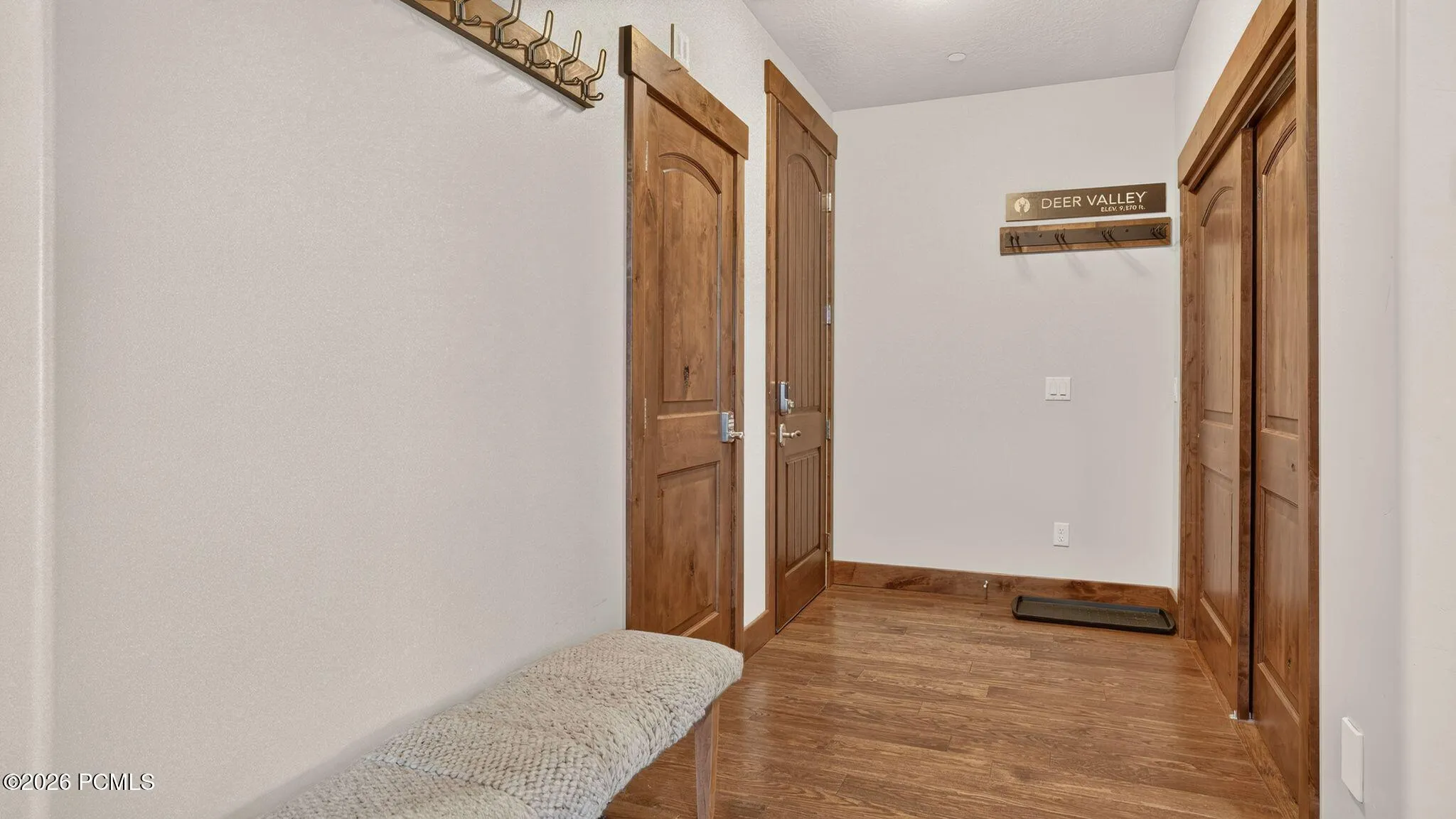 Mudroom entry with bench and hardwood floors - Deer Park 102, Jordanelle, Heber City UT