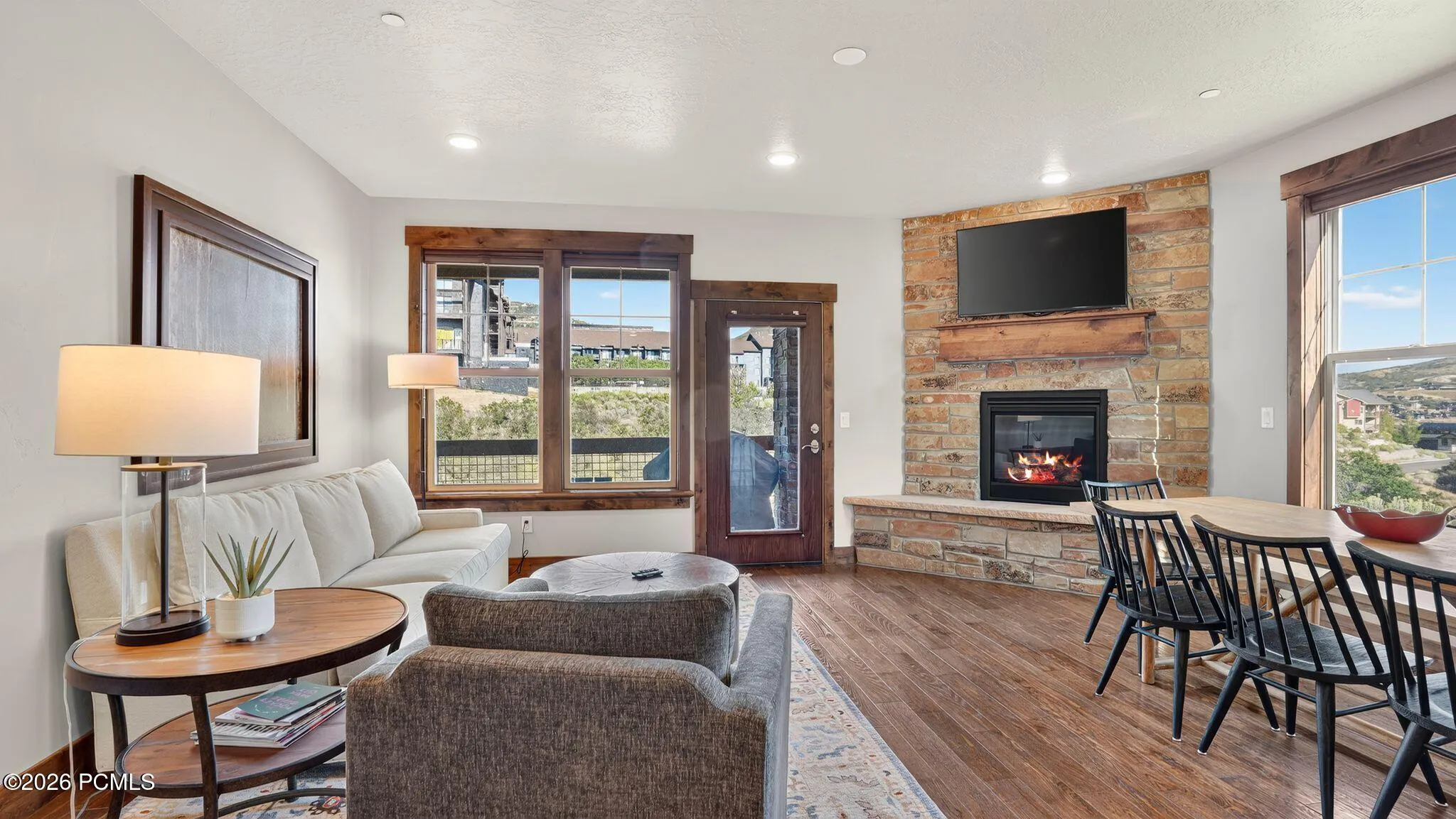 Living room with stone fireplace and valley views - Deer Park 102, Jordanelle, Heber City UT