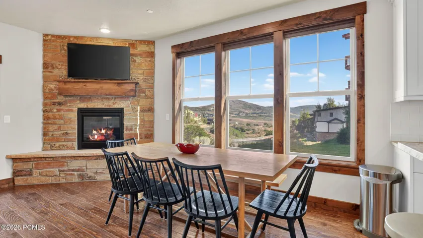 Dining area with stone fireplace and mountain views - Deer Park 102, Jordanelle, Heber City UT