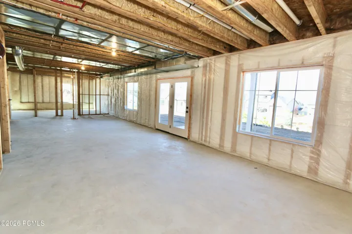 Soon-to-be- finished lower level with 9' ceilings, large windows and walkout French doors to patio