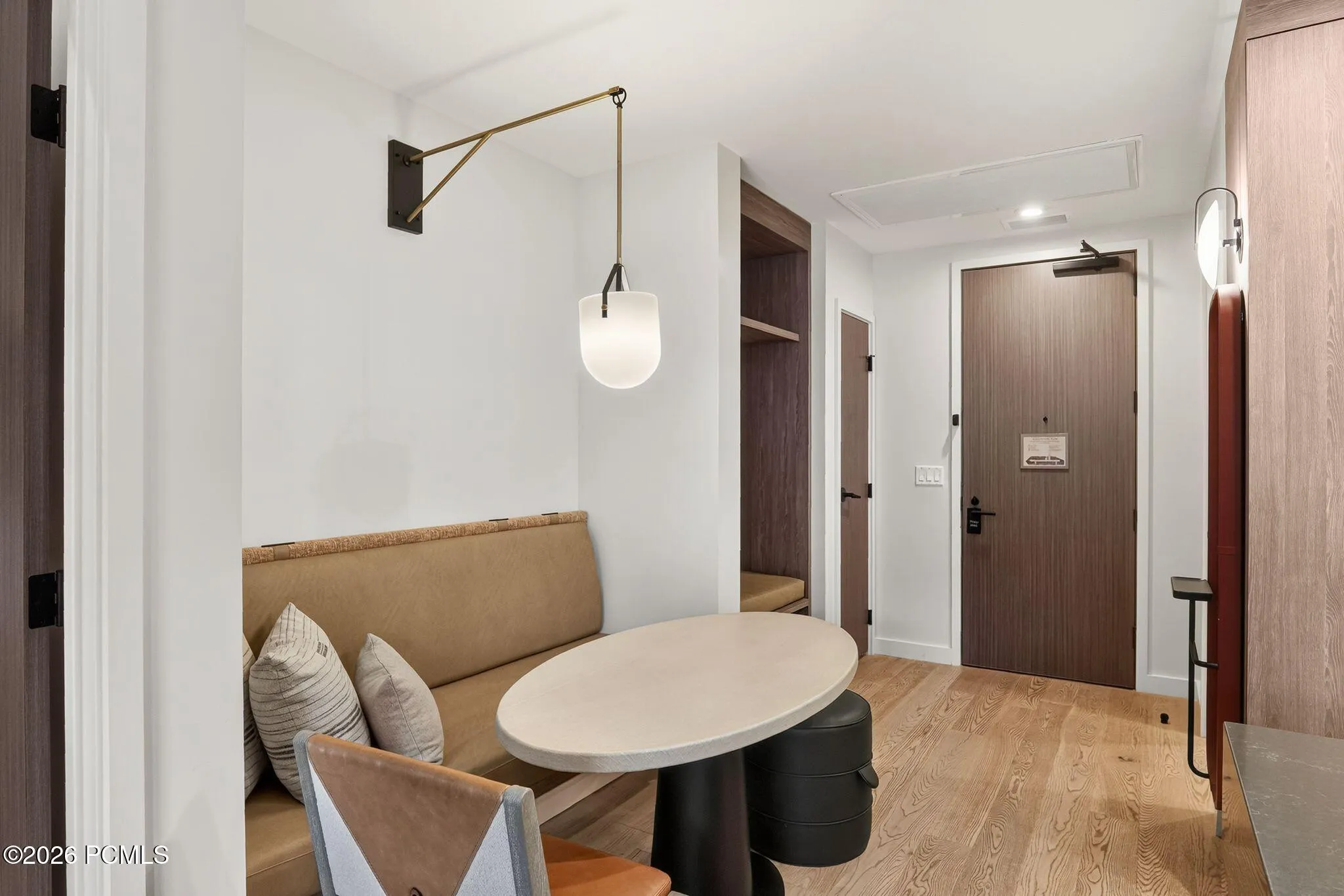 Entry and dining nook with pendant lighting and wide plank flooring.