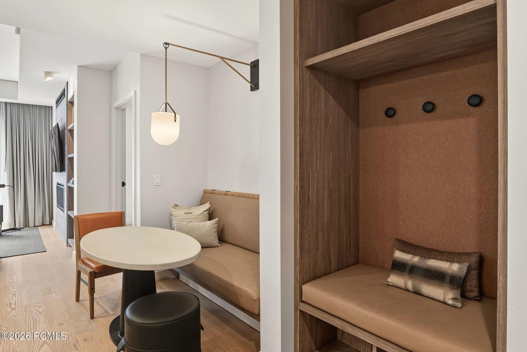 Built in banquette and cafe table create a dining nook just off the entry.