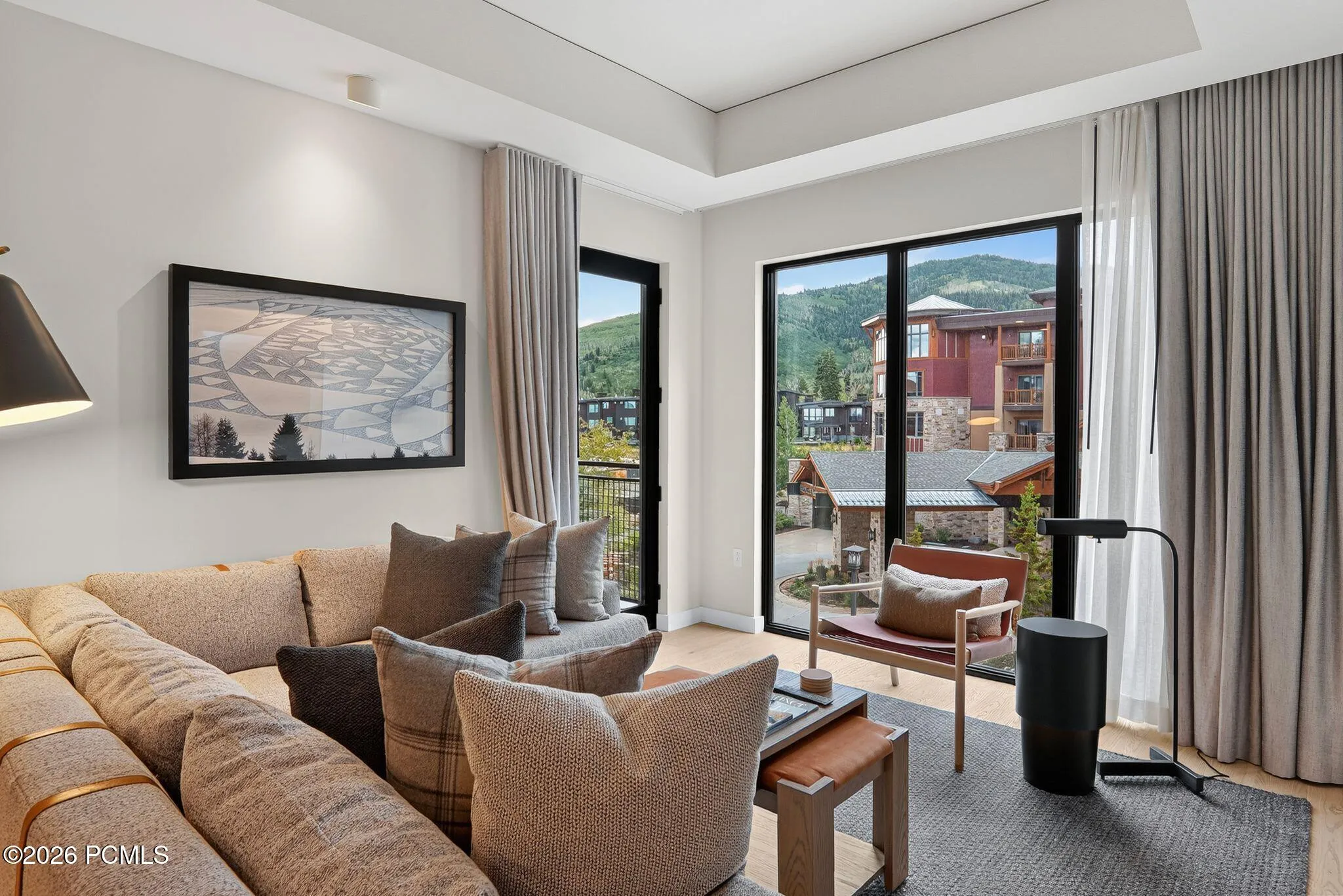 Great room of this ski-in, ski-out residence with sectional seating and windows framing Canyons Village.