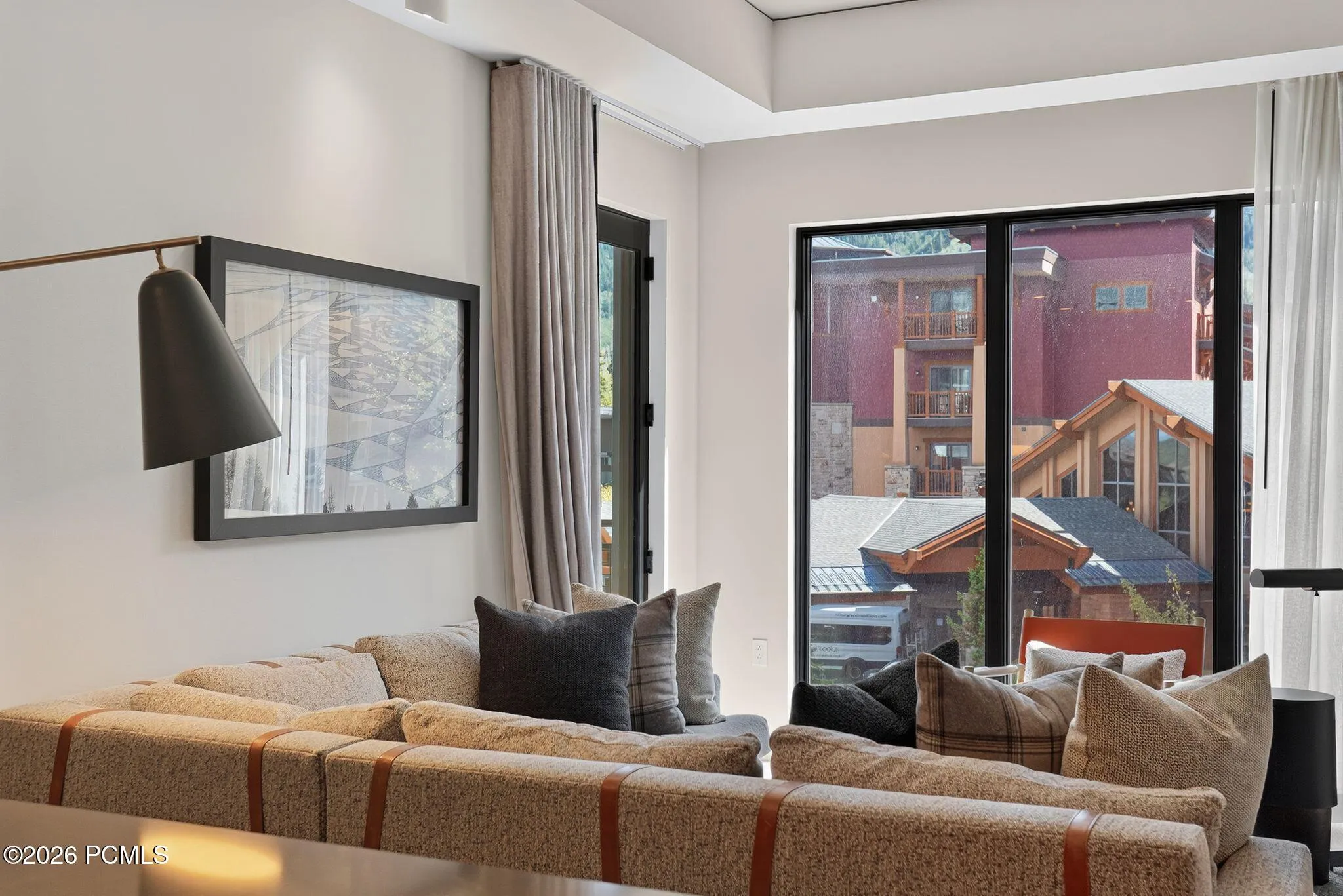 Living area opens through a sliding glass door to the private deck and Canyons Village views.