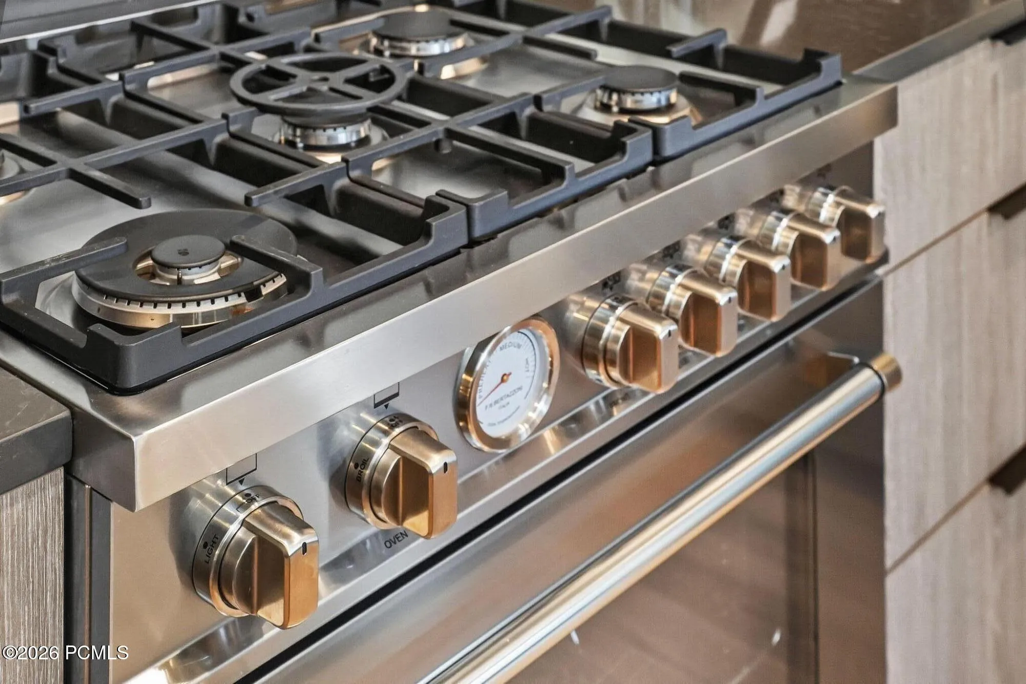 Gas cooktop detail showing the professional grade range in the kitchen.