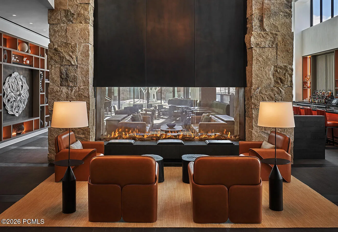 Apres lounge at Pendry Park City built around a double sided stone fireplace, an easy landing spot after last chair.