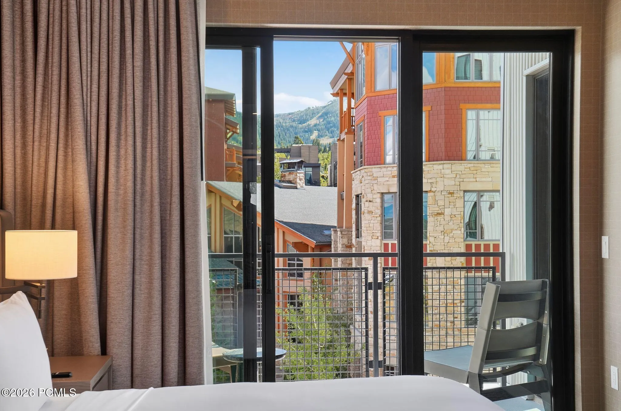 Primary bedroom looking out to Canyons Village from the private balcony.