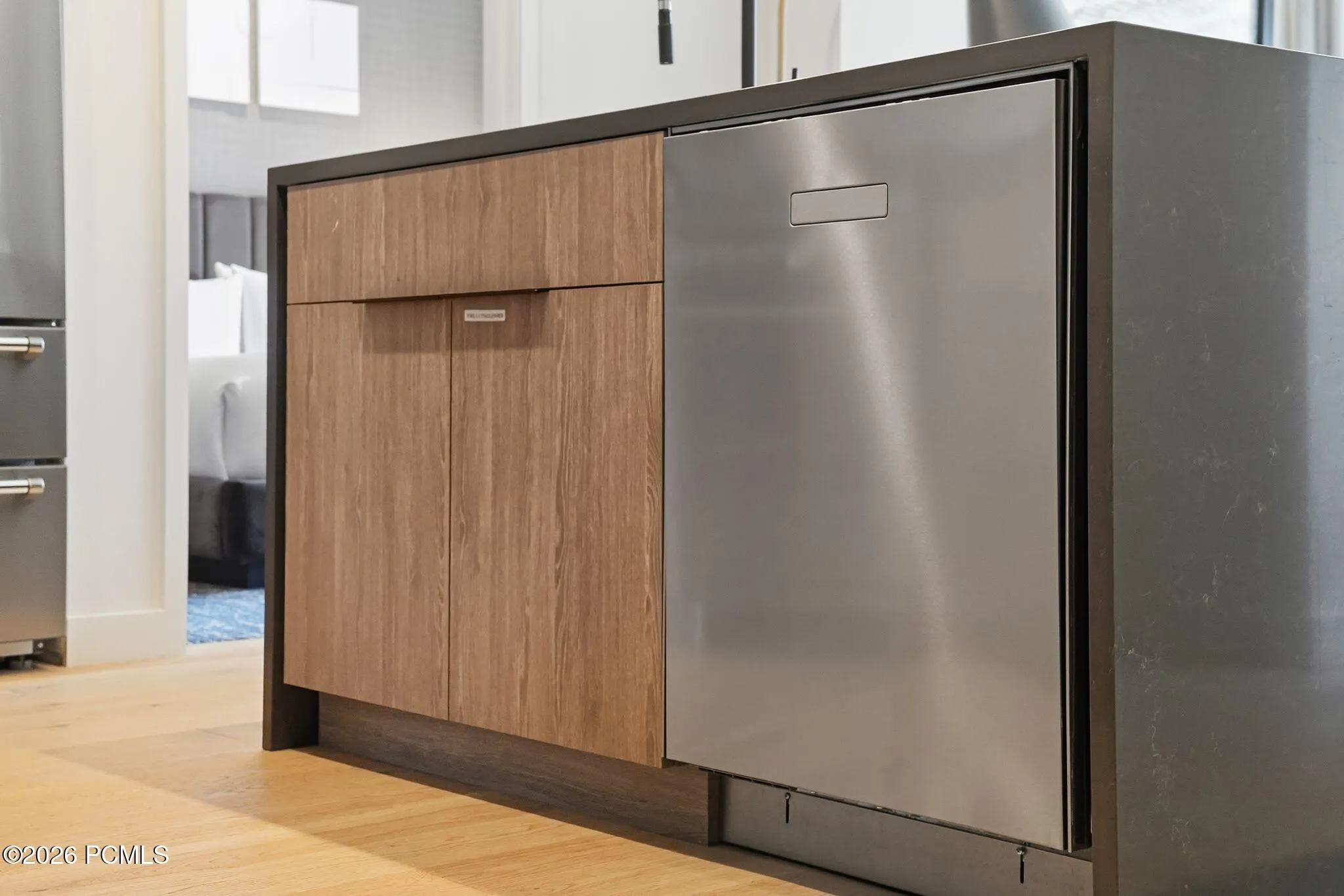 Custom cabinetry with an integrated dishwasher and pull out storage in the kitchen.