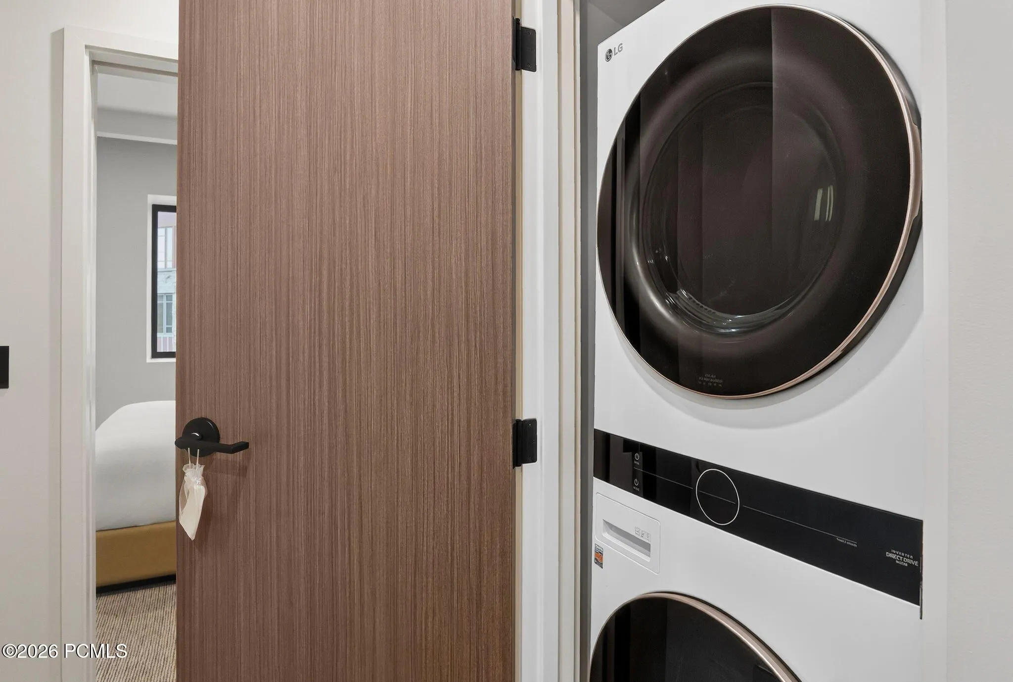 Full size stacked washer and dryer inside the residence.