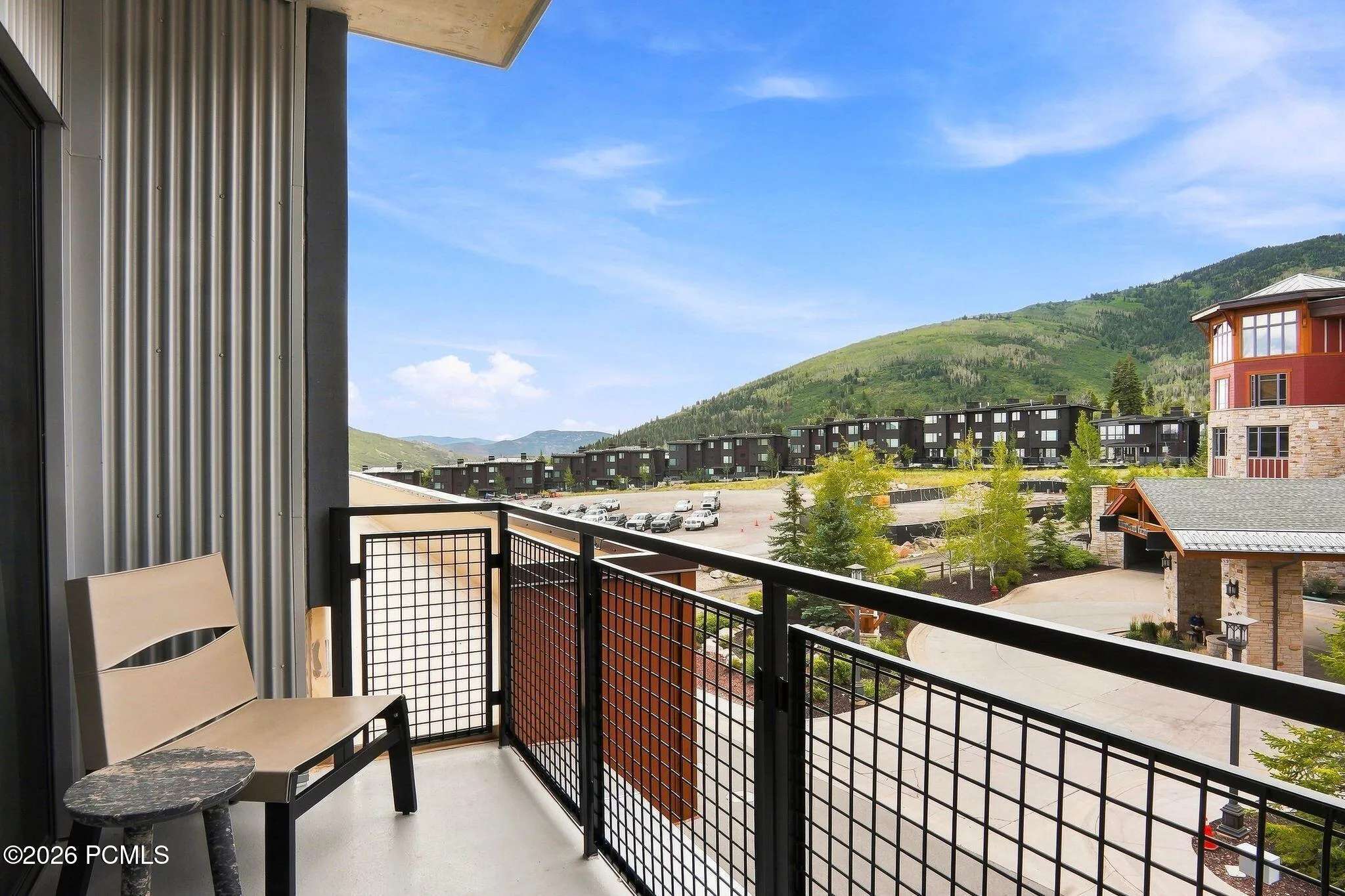 Private covered balcony with seating and open mountain views over Canyons Village.