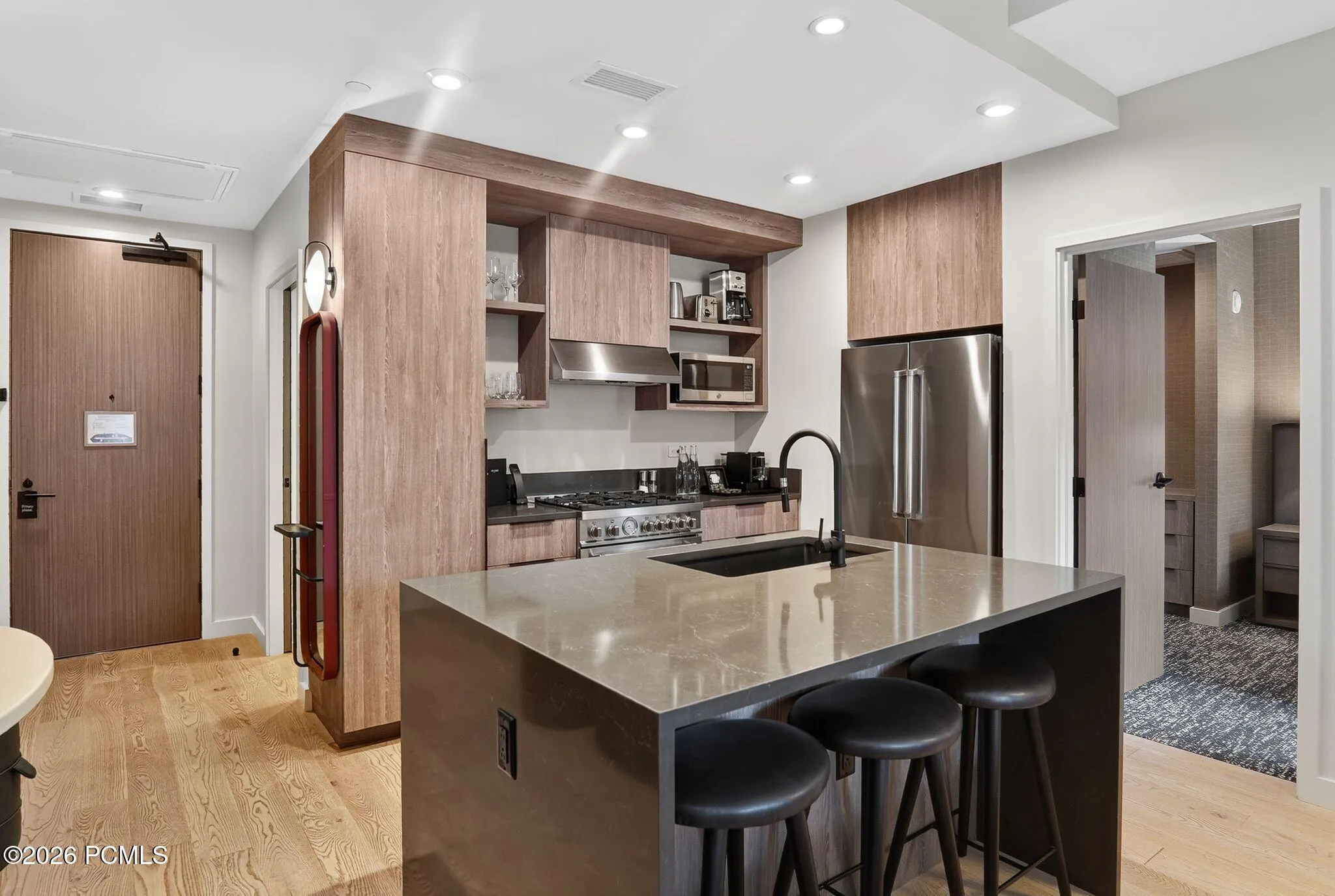 Kitchen looking toward the entry hall of this two bedroom ski-in, ski-out residence at Pendry Park City in Canyons Village.