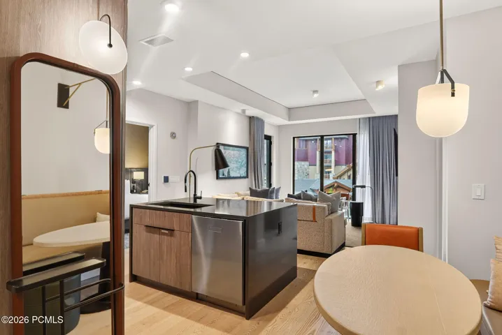 Open concept great room and kitchen with island seating, dining and mountain light throughout.