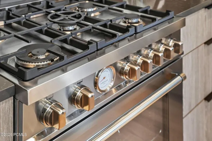 Gas cooktop detail showing the professional grade range in the kitchen.
