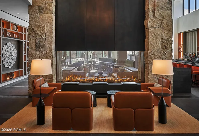 Apres lounge at Pendry Park City built around a double sided stone fireplace, an easy landing spot after last chair.