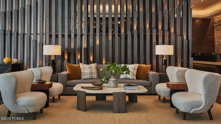 Lobby seating area at Pendry Park City with a fluted wood feature wall, a quiet place to land after a ski day.