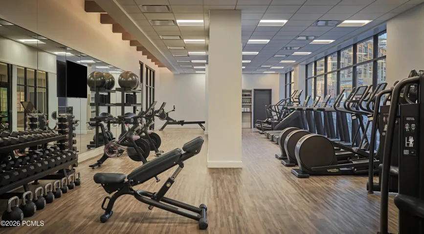 Fitness center at Pendry Park City with free weights, strength equipment and cardio overlooking Canyons Village.
