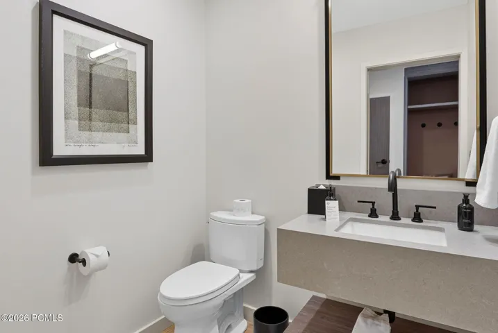 Powder bath with a floating stone vanity and designer lighting.