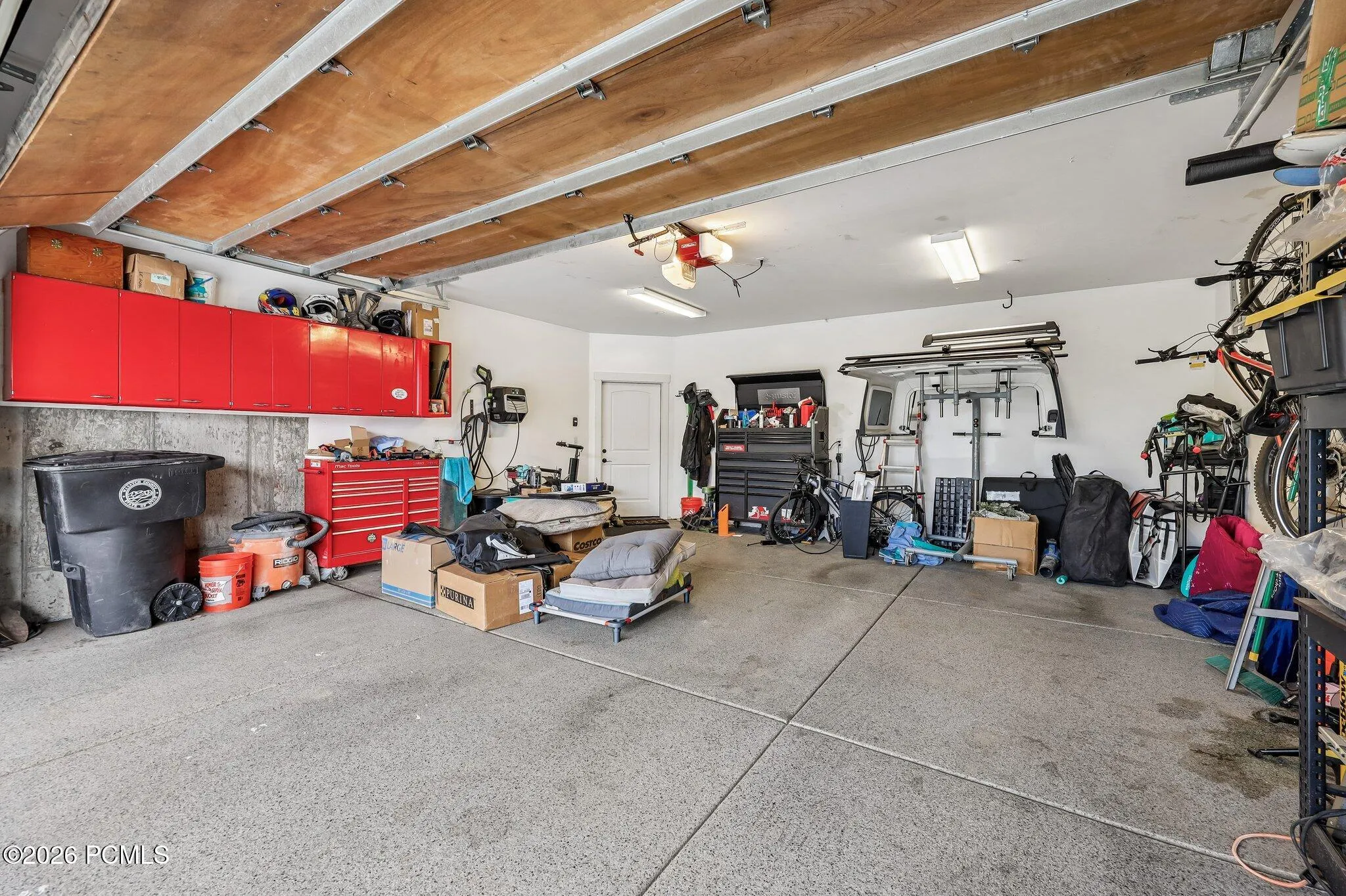 Attached two-car garage on the lower level with bench space and direct interior access in a Rustler at Hideout home.