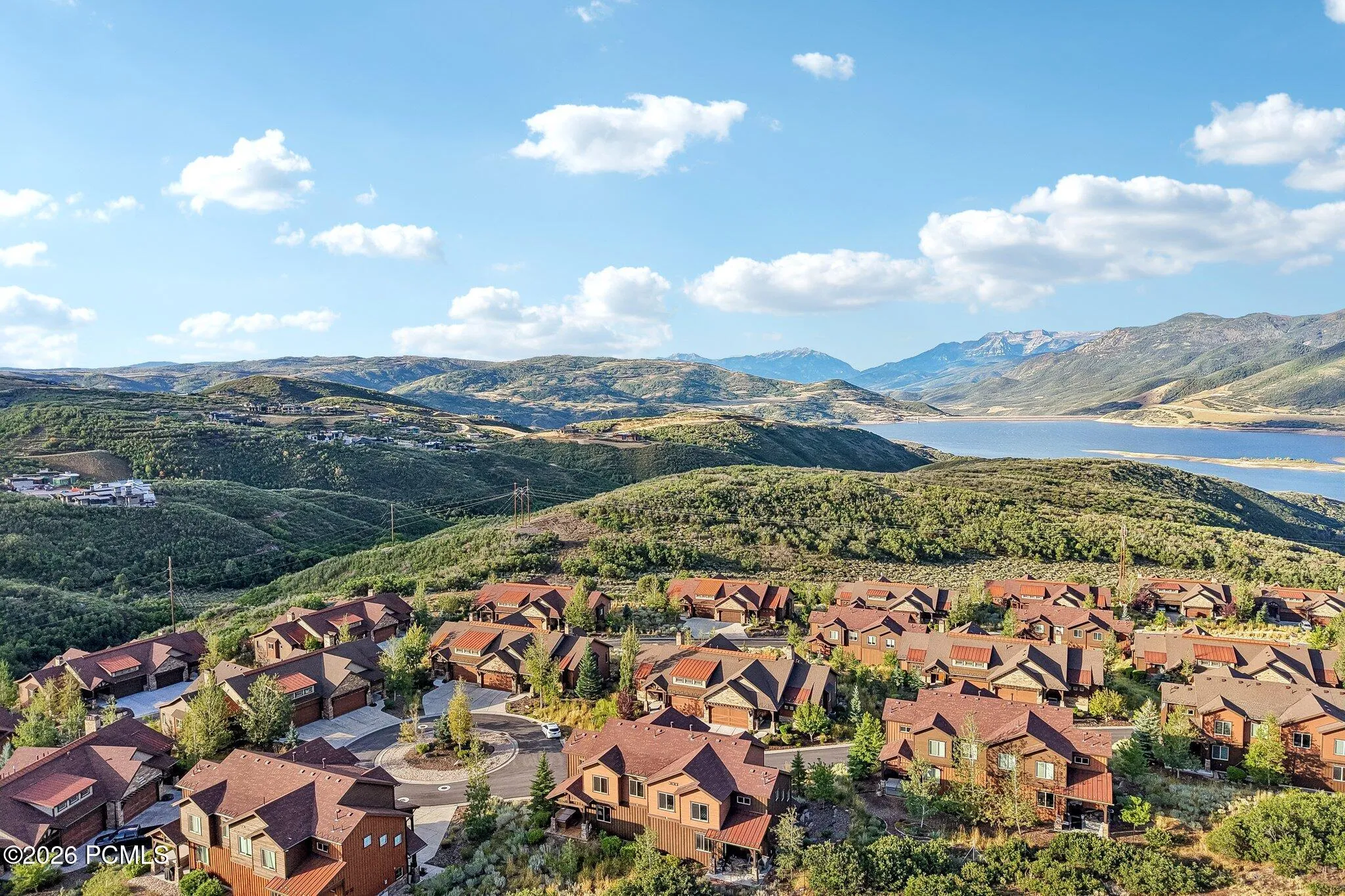 Wide aerial of the Hideout, Utah community with Jordanelle Reservoir beyond, showing open space and quick Highway 40 access to Park City.