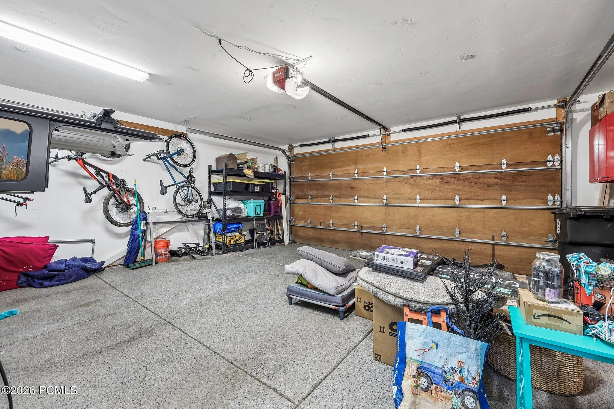 Garage storage wall built out for bikes, skis and boards inside the attached garage of a Hideout, Utah mountain home.