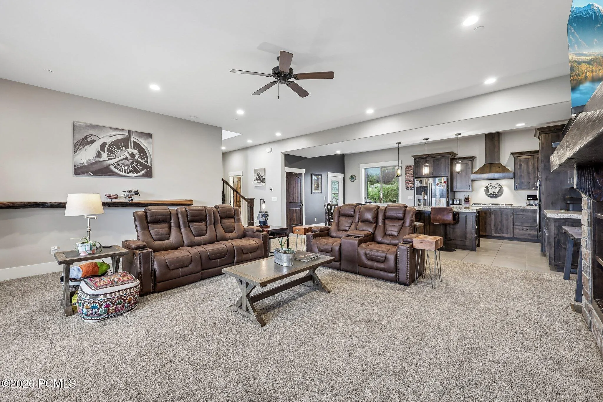 Open-concept main level with the living room, dining area and kitchen in one run, in a Rustler at Hideout home near Jordanelle Reservoir.