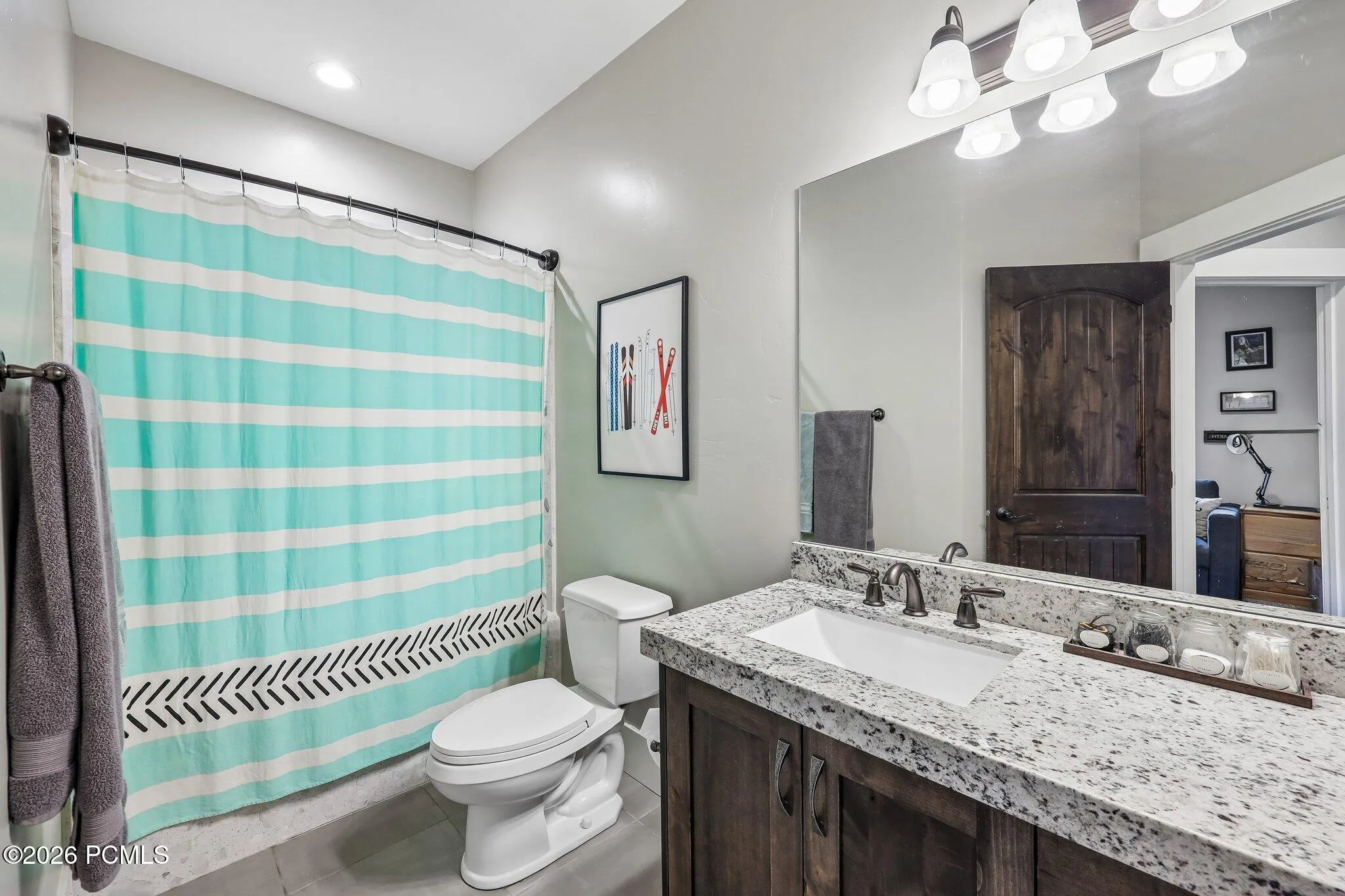 Upstairs full bathroom with a tub-shower combo, granite vanity and shared access from both guest bedrooms.