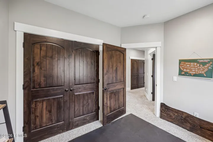 Upstairs hallway connecting two guest bedrooms, a full bath and the primary suite on a single bedroom level.