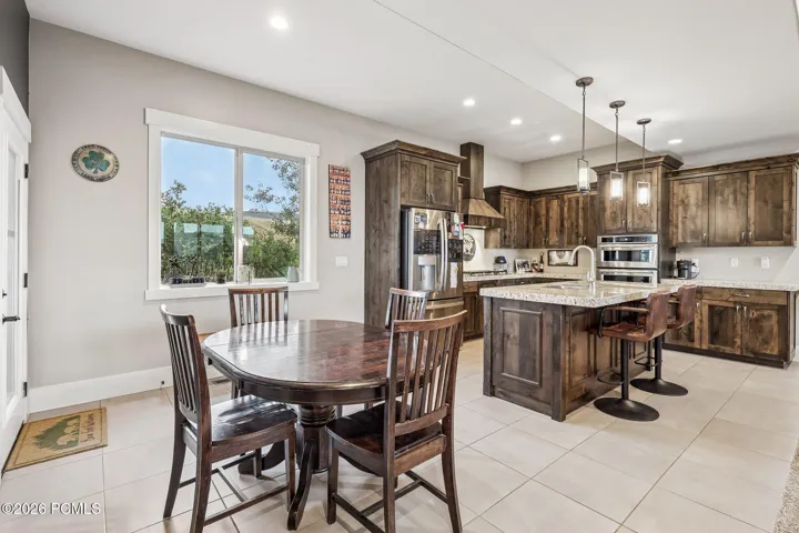 Dining area between the kitchen and windows with seating for six, on the open main level of a Hideout, Utah mountain home.