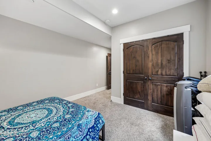 Lower-level guest bedroom with an oversized double closet and space for a king bed, set apart from the main living areas.