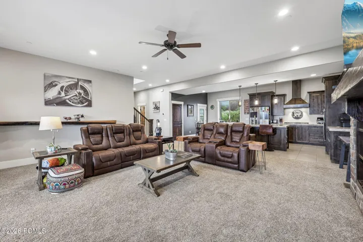 Open-concept main level with the living room, dining area and kitchen in one run, in a Rustler at Hideout home near Jordanelle Reservoir.