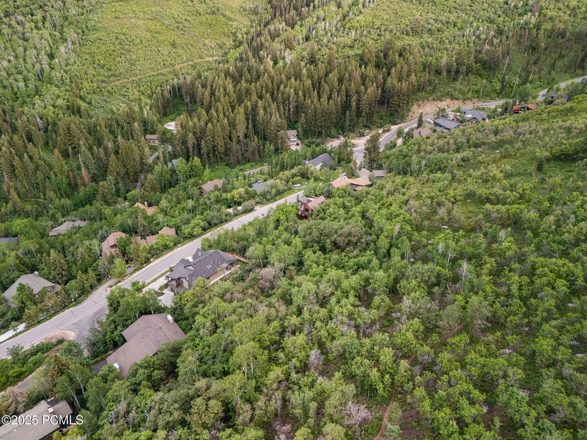 Custom mountain homes tucked into aspen groves along quiet, year-round maintained streets - an established Pinebrook neighborhood with trail access at the door.