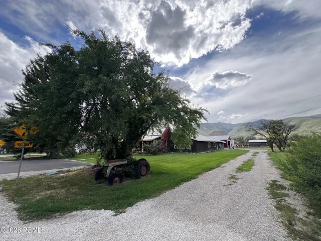 Gravel driveway leading to attached 4 car garage