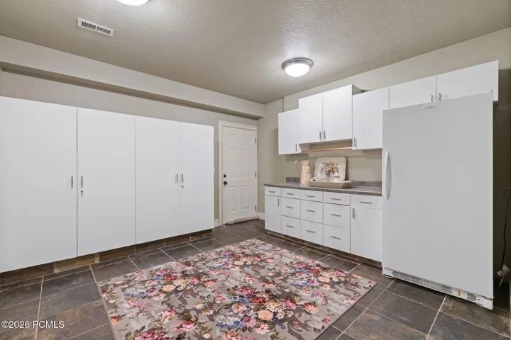 Storage are w/ built in cabinets w/ walkout to garage