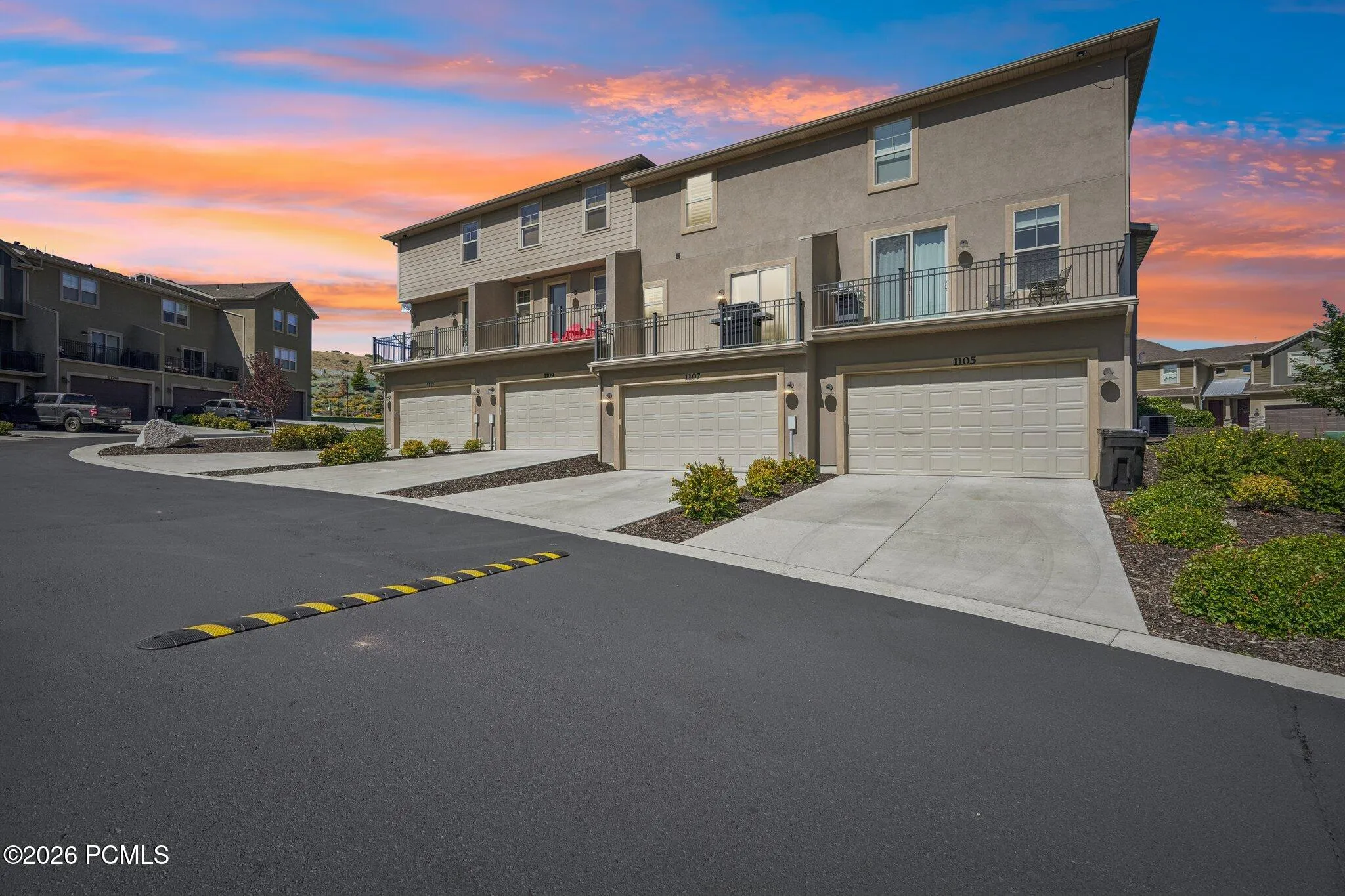 Driveway and garage entries at twilight.