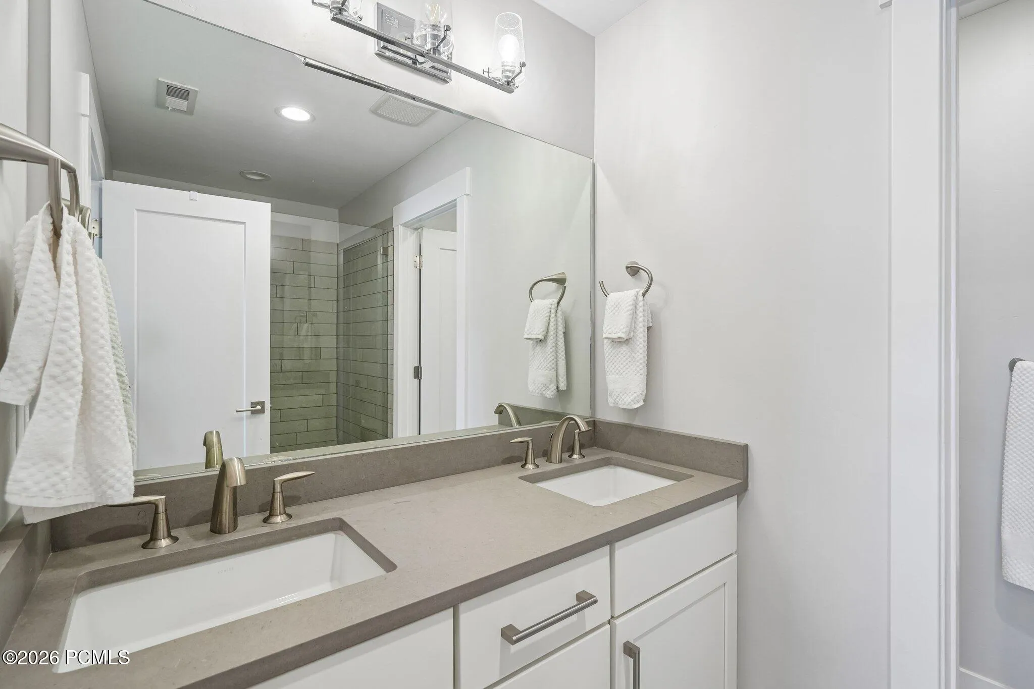 Primary bath with double vanity and quartz counter.