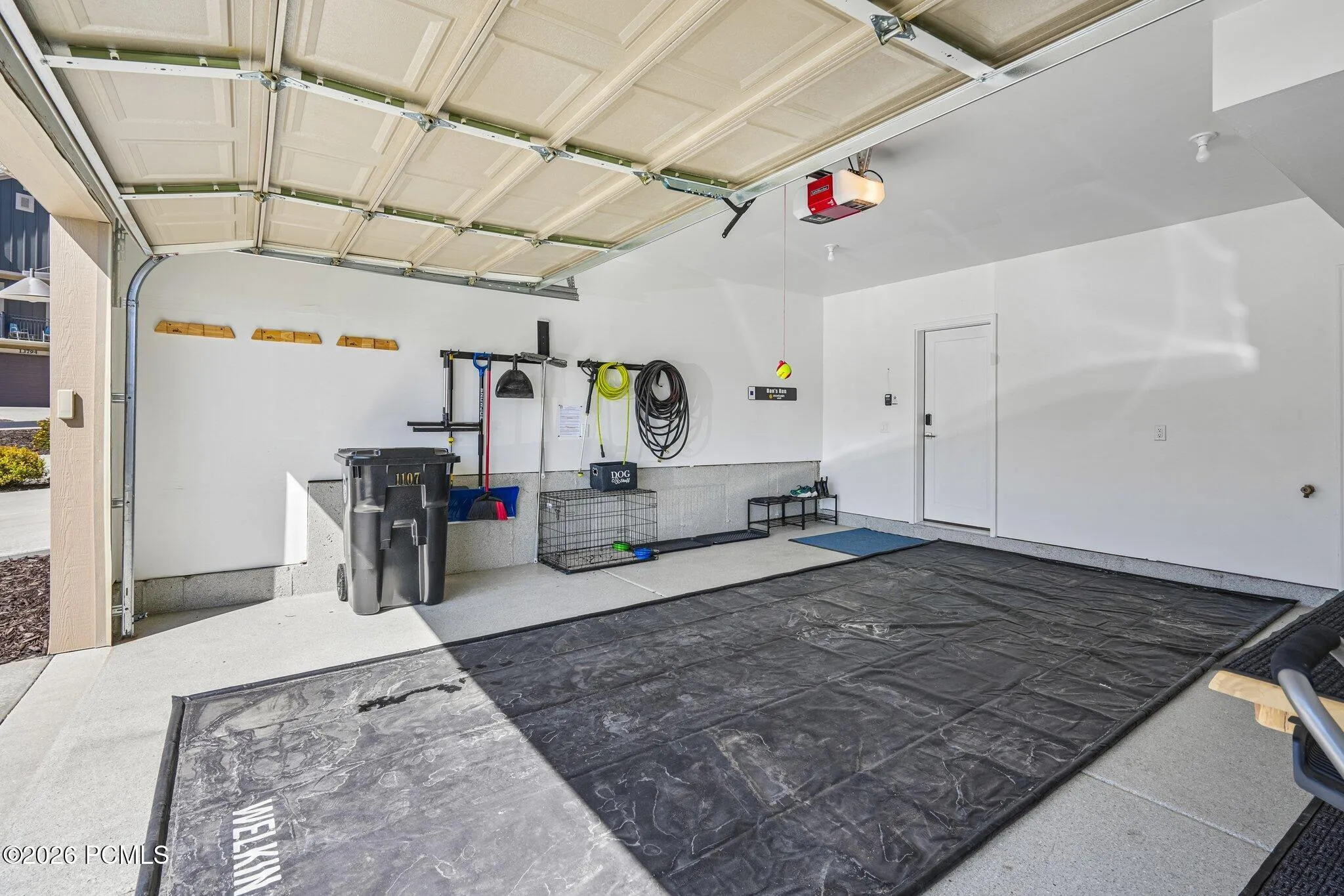 Garage interior with finished walls and room for gear storage.