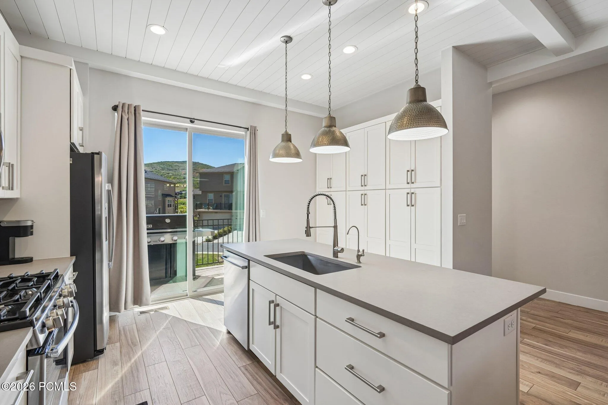 Kitchen island and counter seating with direct access to the patio slider.
