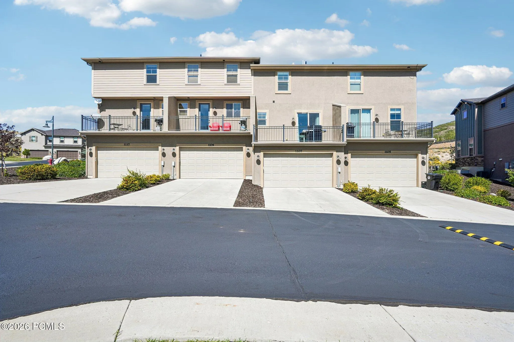 Exterior from the driveway with attached garage access.