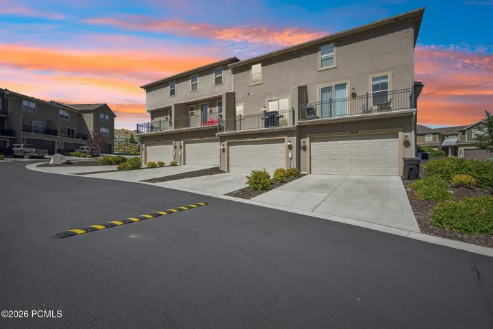 Driveway and garage entries at twilight.